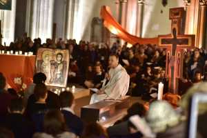 In this Saturday photo, Brother Alois addresses people at an interfaith service for world leaders to curb global warming during a multi-lingual service at Church St Ignatius in Paris, France.