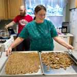 Assembly member Debbie White makes peanut brittle with her son, Brian Keeney, at her home kitchen on Monday. White makes and gives away about 240 pounds of the holiday treat.