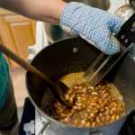 Raw Spanish peanuts get mixed into a boiling sugar and butter mixture as Assembly member Debbie White makes peanut brittle in her home kitchen on Monday.