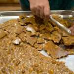 Assembly member Debbie White breaks up peanut brittle she made in her home kitchen on Monday.