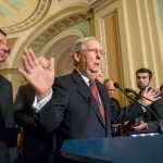 Without mentioning GOP presidential hopeful Donald Trump by name, Senate Majority Leader Mitch McConnell, R-Ky., the top Republican in the Senate, speaks to reporters after saying Trump's remarks about restricting Muslim travel to the United States were "completely and totally inconsistent with American values," during a news conference at the Capitol in Washington, Tuesday, Dec. 8, 2015. McConnell is joined by Sen. John Barrasso, R-Wyo., left.  (AP Photo/J. Scott Applewhite)