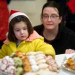 Lauren Sill watches has her daughter, Maggie, 4, select a cookie at the Governor's Open House on Tuesday.