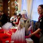 Amanda Mallott helps the Girl Scouts serve hot and cold apple cider during the Governor's Open House on Tuesday.
