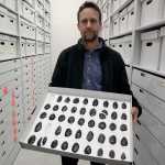 Archeologist Jeff Rasic holds a tray of obsidian tools found in the Nogahabara Dunes west of the Koyukuk River.