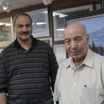 In this Tuesday photo, Sam Obeidi, 58, left, and Mousa Obeidi, 90, pose for a photo in their art gallery in Anchorage. Mousa says he was the first Muslim in Alaska when he arrived in 1964, and his son, Sam, helps new immigrants to Anchorage integrate into the American way of of life.
