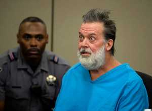 Robert Lewis Dear talks to Judge Gilbert Martinez during a court appearance on Wednesday, Dec. 9, 2015, in Colorado Springs, Colo. Dear, accused of killing three people and wounding nine others at a Colorado Springs Planned Parenthood clinic on Nov. 27, was charged with first-degree murder. (Andy Cross/The Denver Post via AP, Pool)
