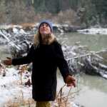 Sonia Nagorski, assistant professor of Geology Arts and Sciences at the University of Alaska Southeast, looks at leaning trees along the bank of the Mendenhall River on Tuesday. The river is nearing the point of cutting through a meander bend just north of the Brotherhood Bridge.