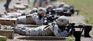FILE - In this Sept. 18, 2012 file photo, female soldiers training on a firing range while wearing new body armor in Fort Campbell, Ky. Members of the U.S. special operations forces say that allowing women to serve in Navy SEAL, Army Delta or other commando units could hurt their effectiveness, lower the standards and drive men away from the jobs. The troops told a Rand Corp. survey that they believe women don't have the physical strength or mental toughness to do the grueling jobs. And their message to political leaders is that when they are fighting in the shadows or bleeding on the battlefield, women have no place on their teams.  (AP Photo/Mark Humphrey, File)