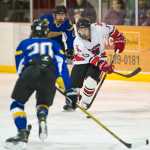 Juneau-Douglas' Jacob Dale, center, drives between Monroe Catholic's Bela Armstrong, foreground, and Grant Olson, background, at Treadwell Arena on Saturday. Monroe Catholic won 3-1.