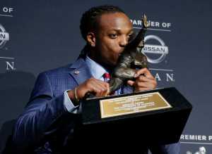 Alabama's Derrick Henry kisses the Heisman Trophy Saturday in New York.