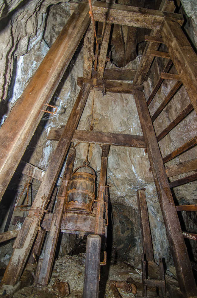 In the Hudson Adit is a 145-foot shaft. This bucket was used to remove rock from the bottom of the shaft.  On the right side of the image is an alarm bell, rung if something happened to the pumps that keep the shaft dry.