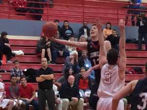 The Crimson Bears' Kaleb Tompkins drive to the basket around Wasilla's Koby Burns on Saturday during the Doc Larson's Round Ball Classic in Wasilla. Juneau-Douglas won 69-57.
