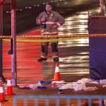 Police and emergency crews respond to the scene after a car drove up onto a sidewalk along Las Vegas Boulevard, Sunday, Dec. 20, 2015, in Las Vegas. A woman intentionally swerved her car onto the busy sidewalk two or three times Sunday and mowed down people outside a Las Vegas casino. (AP Photo/John Locher)