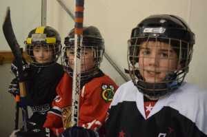 Dylan Miller, John McElmurry and Aidan Kovach are shown at Treadwell Ice Arena on Dec. 15 during a hockey exhibition game with many of the Juneau Douglas Ice Association hockey players who attend Gastineau Elementary.