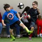 Nutmeggers' Liam Kelly, left, and Snowflake United's Joseph Aline duel for the ball during their elementary division game in the 2015 Holiday Cup at the Dimond Park Fieldhouse on Tuesday.