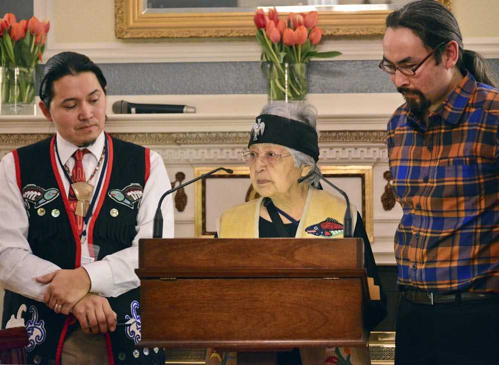 Lance Twitchell, left, and Ishmael Hope stand with Nora Marks Dauenhauer as she reads traditional Tlingit oratory by Naa Tláa (Jessie Dalton of Hoonah) during an Indigenous Readings event hosted by First Lady Donna Walker at the Governor's Mansion in October.