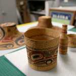 In this Dec. 17 photo, pieces of native artwork from Peter Corey's collection, all weaved by Selina Peratrovich, sit on a table in the Tongass Historical Museum storage room in Ketchikan. When Peter Corey, former curator of the Alaska State Museum and the Sheldon Jackson Museum, died Sept. 20 in Sitka, he left behind a massive collection of Alaska Native art. Now, some of the pieces have found their way home to Ketchikan.