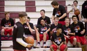 Member of the Juneau-Douglas High School boys basketball team react to a dunk by teammate Bryce Swofford during the ducking contest at the Capital City Classic at JDHS on Sunday. Swofford won the event. Other winners included Caitlin Pusich and Molo Maka, both of JDHS, in the free throw competitions. Chugiak's Nicole Pickney and Kent Lake's Michael Alar won their respective three-point contests.