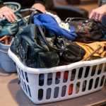 Twenty-three purses filled with toiletries, gloves, scarves, and feminine hygiene products are donated to the AWARE shelter on Monday. Suzanne Dutson, co-founder of the "Juneau Pay-it Forward" Facebook group, after sourcing donations from the community.