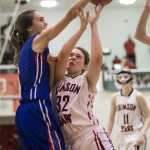 Juneau-Douglas' Cristina Arehart, center, drives against Sitka's Alexandra Kirby during the 2015 Princess Cruises Alaska Airlines Capital City Classic at JDHS on Monday. Juneau won 34-31.