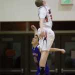Juneau-Douglas' Erik Kelly is called for goal tending against Hydaburg's Joe Hillaire during the 2015 Princess Cruises Alaska Airlines Capital City Classic at JDHS on Monday.