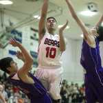 Juneau Douglas' Molo Maka lays the ball up against Hydaburg's Bob Tolson, left, and Michael Eaglestaff during the 2015 Princess Cruises Alaska Airlines Capital City Classic at JDHS on Monday. Juneau won 76-35.