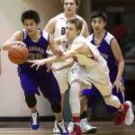 Juneau Douglas' Kolby Hoover, right, tries to steal the ball from Hydaburg's Will Peele during the 2015 Princess Cruises Alaska Airlines Capital City Classic at JDHS on Monday.