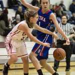 Juneau-Douglas' Erica Hurtte, left, passes around Sitka's Alexandra Kirby during the 2015 Princess Cruises Alaska Airlines Capital City Classic at JDHS on Monday. Juneau won 34-31.