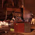 A National Transportation Safety Board investigator takes photos at the scene of an aircraft crash Tuesday in Anchorage.