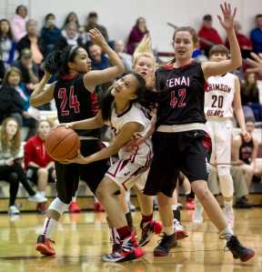 Juneau-Douglas' Alyxn Bohulano, center, looks for the basket between Kenai's Kelsey Booth, left, and Brooke Satathite during the Princess Cruises Alaska Airlines Capital City Classic at JDHS on Tuesday.