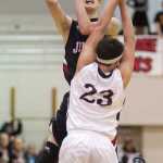 Juneau-Douglas' Kaleb Tompkins shoots over Kent Lake's Justin Olson during the Princess Cruises Alaska Airlines Capital City Classic on Wednesday. Kent Lake won 53-48.