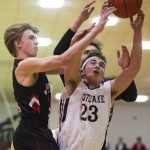 Juneau-Douglas's Kolby Hoover, left, and teammate Bryce Swofford challenge Kent Lake's Justin Olson for a rebound during the Princess Cruises Alaska Airlines Capital City Classic on Wednesday. Kent Lake won 53-48.