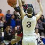 Juneau-Douglas' Ulyx Bohulano drives to the basket against Kent Lake's Trey Helgeson during the Princess Cruises Alaska Airlines Capital City Classic on Wednesday. Kent Lake won 53-48.