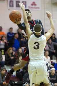 Juneau-Douglas' Ulyx Bohulano drives to the basket against Kent Lake's Trey Helgeson during the Princess Cruises Alaska Airlines Capital City Classic on Wednesday. Kent Lake won 53-48.