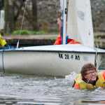 Youth sailing instructor Johnny Connolly uses his teeth to pull a sailing dinghy with Liam Penn, left, and Gavin Millard in it during Juneau Youth Sailing lessons at Aurora Harbor on July 13. The students, ages 11 to 13, are in a week-long level one class.