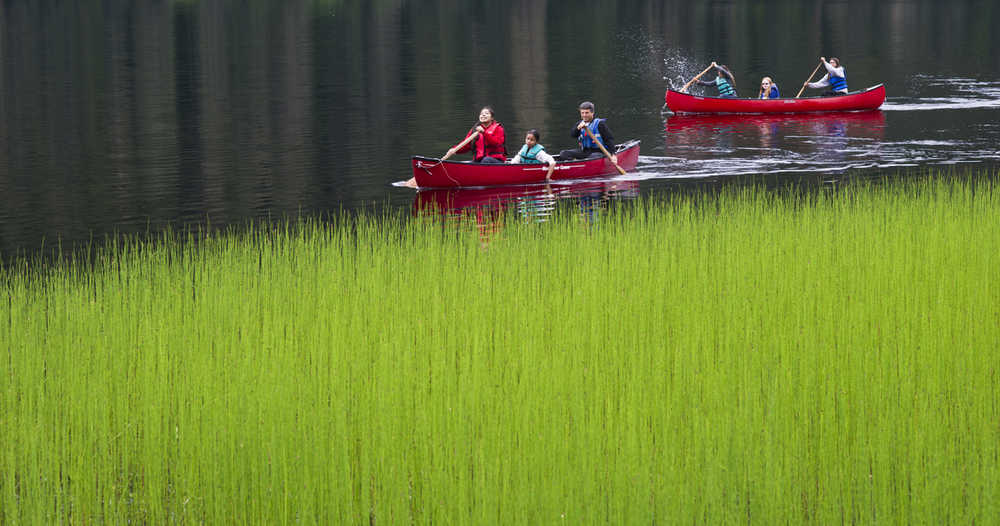 Instructor Fred Hiltner canoes with middle school students Starr George, 13, left, and Halley Washington, 11, as Arianna Hinchman, 13, Mackenzie Gray, 11, and Pearl Sharclane, 12, follow during trip on Auke Lake to study math in a place-based setting on June 25. The week-long Summer Math Academy offered by the Sealaska Heritage Instituite presented middle school-aged students culture and math concepts through traditional practices, such as basketry, canoeing and making bentwood boxes.