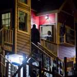 Juneau Police Chief Bryce Johnson talks with detectives at the front door of Mayor Greg Fisk's house on Kennedy Street the night on Nov. 30.