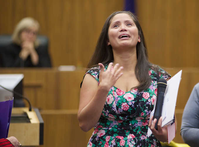 New citizens, 33 total, take an oath during the United States Citizenship and Immigration Services' Naturalization Ceremony at the Robert Boochever Courthouse at the Juneau Federal building on Aug. 21.
