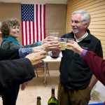 Greg Fisk gets help toasting his win for mayor of Juneau over Merrill Sanford by Patty Ware, left, Patricia Hull and Janet Kussart, right, at his Seward Street campaign headquarters on Oct. 6.