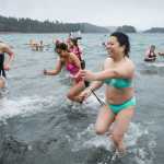 Hundreds of swimmers race from the sea during the 24th annual Polar Bear Dip at the Auke Village Recreation Area on Friday, Jan. 1, 2016.