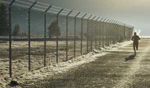 Weather Potdevin's breath lingers in the cold air during a run along the Aiport Dike Trail on Monday.