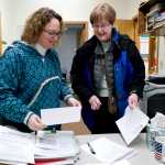 Cheryl Jebe, right, turns her paperwork to apply for the District 1 Assembly seat with Deputy Clerk Beth McEwen at City Hall just in time for the 4:30 deadline on Tuesday.