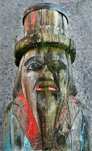 Jodi DeBruyne, Curator of Collections & Exhibits for the Juneau-Douglas City Museum, takes a moment to inspect the weather damage to the Wooshkeetaan Totem Pole (JDCM 81.01.027) as it is moved into the city's Parks Maintenance building in Douglas on Tuesday. The 40-foot totem, carved by Nathan Jackson in 1980 with assistance by Steve Brown and assstance painting by his wife, Dorica Jackson, was placed in the Museum's collection in 1981 and erected outside Centennial Hall for Juneau's Centennial in 1983. The pole was taken down Tuesday for restoration.