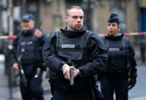 Police officers secure the perimeter near the scene of a fatal shooting which took place Wednesday at a police station in Paris.