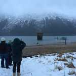 Mackenzie Burnett, Kelly Burnett, and group leader Patty Rose count surf scoters during Juneau's 43rd annual Christmas Bird Count, held Jan. 2. A raft of 175 scoters floats behind the pilings.