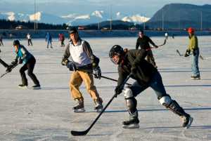 Alan Steffert passes a puck during a lunch-time game of hockey on the ice at Twin Lakes on Thursday. The National Weather Service forecast for Friday calls for sunny with highs 27 to 35. Northeast wind 10 mph.