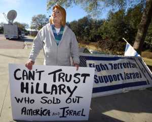 Bob Kunst, of Miami Beach, Fla., wears a Hillary Clinton as he stands outside the North Charleston Coliseum, Wednesday, Jan. 13, 2016, in North Charleston, S.C., in advance of Thursday's Fox Business Network Republican presidential debate. (AP Photo/Rainier Ehrhardt)
