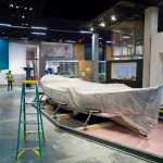 A Bristol Bay double-ender fishing boat is shrouded in a sheet of protective plastic inside the permanent gallery under construction at the Alaska State Library, Archives, and Museums building.