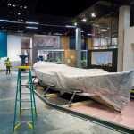 A Bristol Bay "double-ender" fishing boat is shourded in a sheet of protective plastic inside the permanent gallery under construction at the Alaska State Library, Archives, and Museums building.