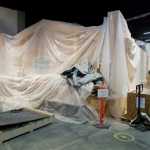A clan house is shourded in a sheet of protective plastic inside the permanent gallery under construction at the Alaska State Library, Archives, and Museums building.